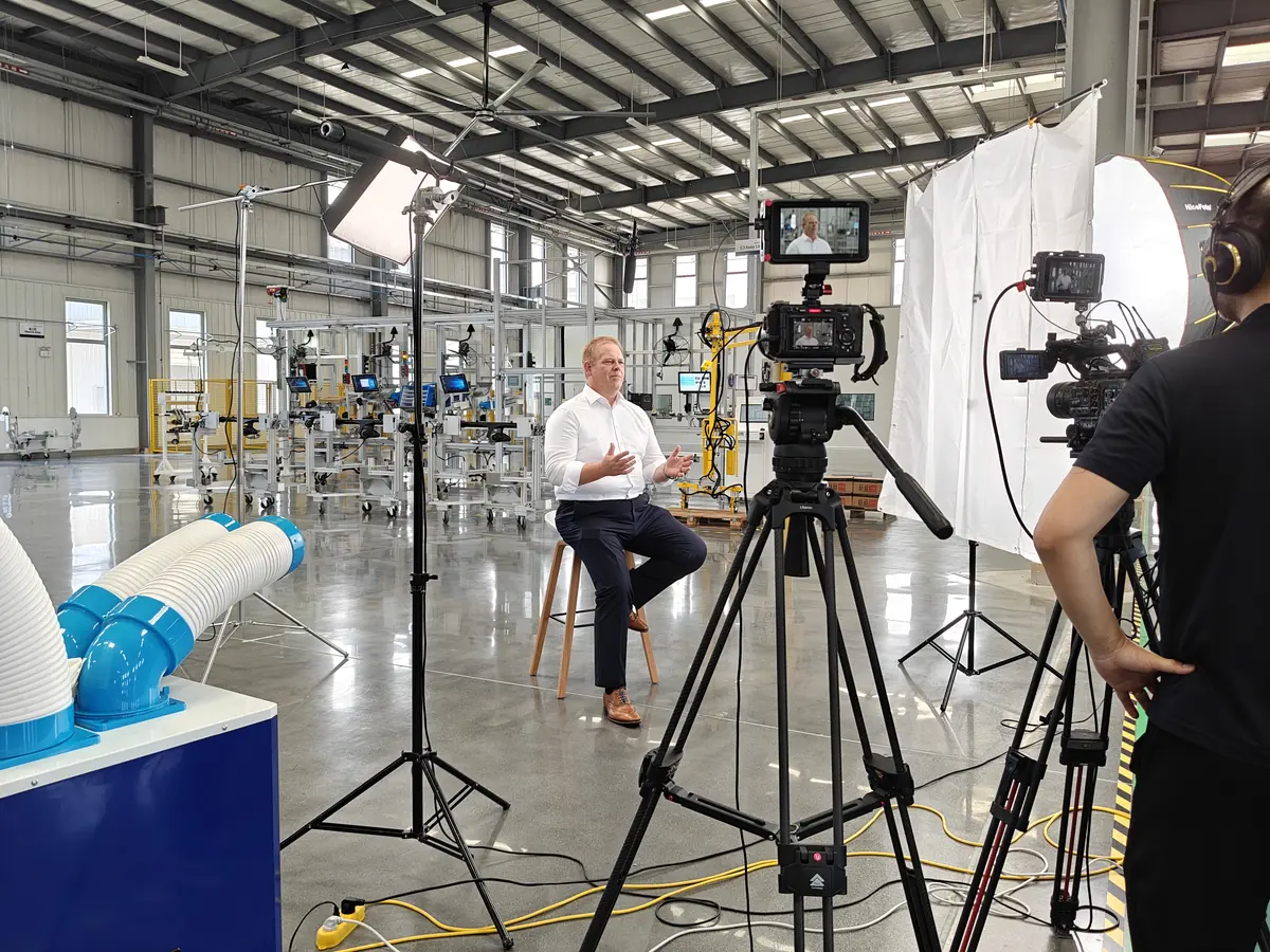 Videographer filming an industrial interview